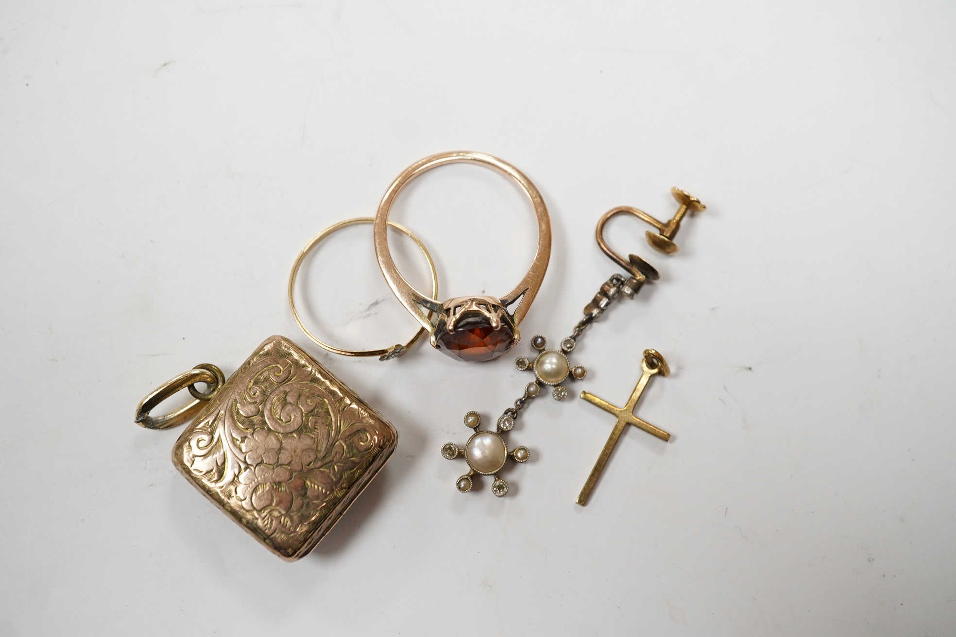 Sundry jewellery including a yellow metal and hessonite garnet set ring, a single yellow metal, seed pearl and diamond cluster set drop earring, locket, cross and a ring. Condition - poor to fair